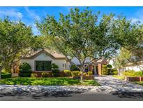 Charming single-story home with a well-manicured lawn, mature trees and a charming garden at 9608 Camden Hills Ave, Las Vegas, NV 89145