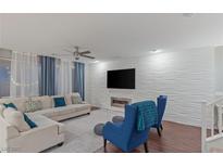 Bright living room featuring a modern fireplace, textured wall, and comfortable seating arrangement at 12382 Piazzo St, Las Vegas, NV 89141