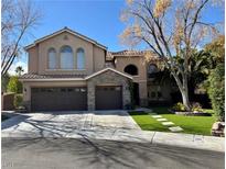 Charming two-story home featuring a three-car garage and stone accents at 1705 Pink Cliff Ct, Las Vegas, NV 89128