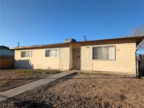 Charming single-story home with a low-maintenance front yard and a classic desert landscape at 1912 W Carey Ave, North Las Vegas, NV 89032