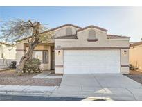 Charming single-story home featuring a well-maintained front yard and two-car garage at 2132 Fred Brown Dr, Las Vegas, NV 89106