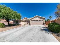 Charming single-story home with a three car garage, desert landscaping and light beige paint at 3412 Amish Ave, North Las Vegas, NV 89031
