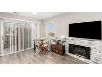 Inviting living room featuring a fireplace and sliding glass doors to the outside at 5015 Spencer St # C, Las Vegas, NV 89119