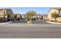 View of homes and street in a well-maintained neighborhood with sidewalks at 5392 Blustery Towns Ave, Las Vegas, NV 89118