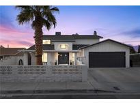 Inviting two-story home with well-manicured landscaping and a spacious two-car garage at 638 Paloma Dr, Boulder City, NV 89005