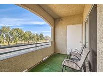 Relaxing balcony featuring two chairs and views of nearby greenery at 833 Aspen Peak Loop # 1721, Henderson, NV 89011