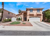 Charming home with a two-car garage, arched windows, and a beautifully manicured front yard at 8348 Brittany Harbor Dr, Las Vegas, NV 89128