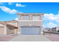 Two-story home with a two-car garage and neutral-colored gravel landscaping at 972 Orchid Vine Ct, Las Vegas, NV 89183