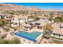 Desert home boasts an inviting pool, mountain views and lush surroundings in a desirable neighborhood at 11473 Glowing Sunset Ln, Las Vegas, NV 89135