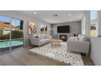 Bright living room boasts recessed lighting, luxury flooring, modern decor, and seamless access to the outdoor pool area at 1620 Western Lily St, Las Vegas, NV 89128