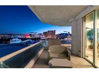 Balcony at night with comfortable seating overlooking the vibrant Las Vegas skyline at 2877 Paradise Rd # 2703, Las Vegas, NV 89109