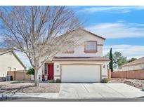 Charming home featuring a two-car garage, red front door, and low-maintenance landscaping at 3400 Crystal Tower St, Las Vegas, NV 89129