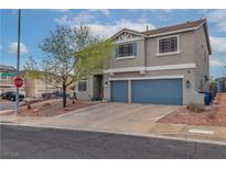 Two-story home featuring a two-car garage, neat landscaping, and a welcoming front porch at 36 Vista Del Mar St, Henderson, NV 89012