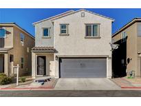 Two-story home with a gray two-car garage and neutral stucco exterior at 3686 Via Sonja Ave, Las Vegas, NV 89115