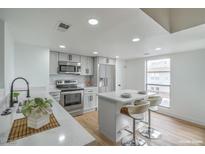 Bright kitchen features stainless steel appliances and a center island with bar seating at 3790 Shirebrook Dr # 167, Las Vegas, NV 89115