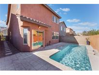 View of a pristine pool in a private backyard setting featuring a tiled patio and stucco privacy wall at 4740 Killington St, Las Vegas, NV 89129
