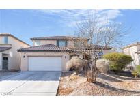 Charming two-story home featuring a spacious two-car garage and low maintenance landscaping at 5471 Hidden Rainbow St, North Las Vegas, NV 89031