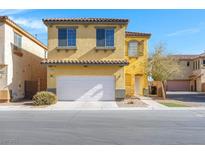 Charming two-story home features a white garage door, terracotta roof tiles and a yellow stucco exterior at 648 Sumatra Pl, Henderson, NV 89011