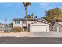 Charming two-story home with a two car garage, desert landscaping and large palm tree at 3886 Green Leaf Dr, Las Vegas, NV 89120
