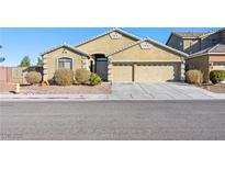 Inviting single-story home showcasing a three car garage and desert landscaping at 6360 Bullring Ln, Las Vegas, NV 89130