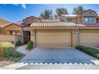 Charming townhome featuring a tile roof and an attached two-car garage at 7385 Mission Hills Dr, Las Vegas, NV 89113