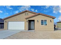 Charming single-story home featuring a two-car garage, landscaped yard, and tile roof at 790 E Basin, Pahrump, NV 89060