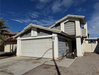 Charming two-story home featuring a two-car garage and a well-maintained front yard under a bright blue sky at 8152 Cactus Flower Ct, Las Vegas, NV 89145