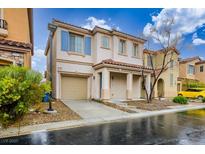 Charming two-story home featuring desert landscaping, blue shutters, and a two-car garage at 10560 La Campana St, Las Vegas, NV 89179