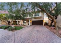 Charming two-story home featuring a brick driveway and well-maintained landscaping at 11017 Ladyburn Ct, Las Vegas, NV 89141