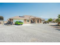 Charming single-story home with a two-car garage and ample parking on a gravel driveway at 1920 Silver St, Pahrump, NV 89048