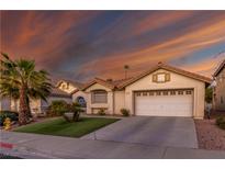 Charming single-story home with a well-manicured lawn and a two-car garage in a residential neighborhood at 254 Camelback Ridge Ave, Henderson, NV 89012