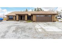 Charming single-story home with a well-maintained desert landscape and tile roof at 3051 S Rainbow Ave, Pahrump, NV 89048