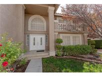 Charming entryway with white double doors, arched window, and manicured landscaping at 3120 Stern Dr, Las Vegas, NV 89117