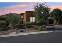 Charming single-story home with desert landscaping, brick pathway, and a warm, inviting curb appeal at 10057 Regency Canyon Way, Las Vegas, NV 89148