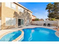 Backyard pool area featuring a uniquely shaped pool and outdoor furniture at 10273 Grecian Laurel Ct, Las Vegas, NV 89183