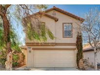 Two-story stucco home with a two-car garage and low maintenance desert landscaping at 11147 Verismo St, Las Vegas, NV 89141
