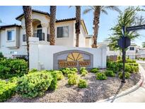 Inviting community entrance sign surrounded by lush greenery and mature palm trees at 4910 Black Bear Rd # 104, Las Vegas, NV 89149