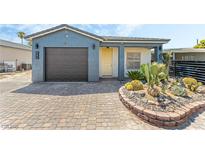 Charming single-story home with a desert landscape and paved driveway at 605 N Yale St, Las Vegas, NV 89107