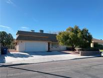 Charming single-story home with a well-manicured front yard and a two-car garage at 7077 Hillcroft Way, Las Vegas, NV 89147