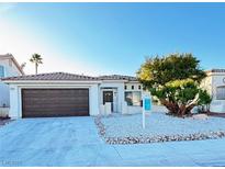 Charming single-story home featuring desert landscaping, a two-car garage and tile roof at 7329 Cogburn St, Las Vegas, NV 89131