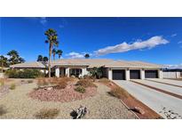 Beautiful single-story home with manicured desert landscaping and a three-car garage at 8290 Gagnier Blvd, Las Vegas, NV 89113