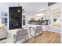 Bright living room with a modern fireplace, high ceilings, and an open floor plan at 9 White Tail Ct, Henderson, NV 89074