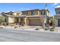 Inviting two-story home with desert landscaping, a two car garage and neutral color palette at 12836 Alcores St, Las Vegas, NV 89141