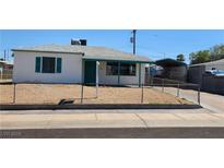 Cozy single-story home featuring a low-pitched roof, green trim, and a chain-link fenced yard at 17 Mallory St, Henderson, NV 89015