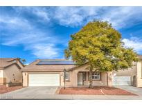 Charming single-story home with a well-manicured yard, solar panels, and a two-car garage at 904 Melic Way, North Las Vegas, NV 89032
