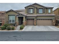 Two-story home with a three-car garage and a well-maintained front yard and stone veneer at 10215 Radcliffe Peak Ave, Las Vegas, NV 89166