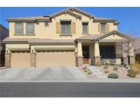 Inviting two-story home with a three-car garage and well-maintained landscaping at 10220 Radcliffe Peak Ave, Las Vegas, NV 89166