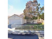 Charming single-story home featuring a well-maintained front yard and attached garage at 1411 Watercreek Dr, North Las Vegas, NV 89032