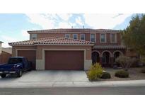 Charming two-story home featuring a terracotta roof and a spacious three-car garage at 1633 Dornie Ave, North Las Vegas, NV 89084