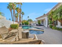 Beautiful backyard pool with a spa and lush landscaping is perfect for outdoor entertaining at 174 Buena Ct, Henderson, NV 89074